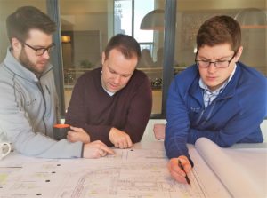 A color photo of staff at the downtown Minneapolis office of Landform Professional Services LLC working together on a plot for a city project. This was shared by Minneapolis Minnesota company Landform Professional Services that offers: Landscape Design, Landscape Architecture, Urban Planning, Urban Design, Civil Engineer, Drone Operator, Landscape Designer Civil Engineering, Land Surveying and drone/aerial operations for small, medium and large businesses and residences throughout the USA. You can contact Landform at www.landform.net.