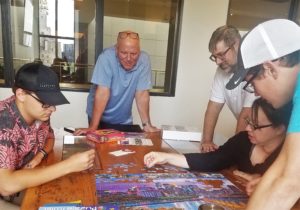 A color photo of staff at the downtown Minneapolis office of Landform Professional Services LLC working together to put a puzzle together. This was shared by Minneapolis Minnesota company Landform Professional Services that offers: Landscape Design, Landscape Architecture, Urban Planning, Urban Design, Civil Engineer, Drone Operator, Landscape Designer Civil Engineering, Land Surveying and drone/aerial operations for small, medium and large businesses and residences throughout the USA. You can contact Landform at www.landform.net.